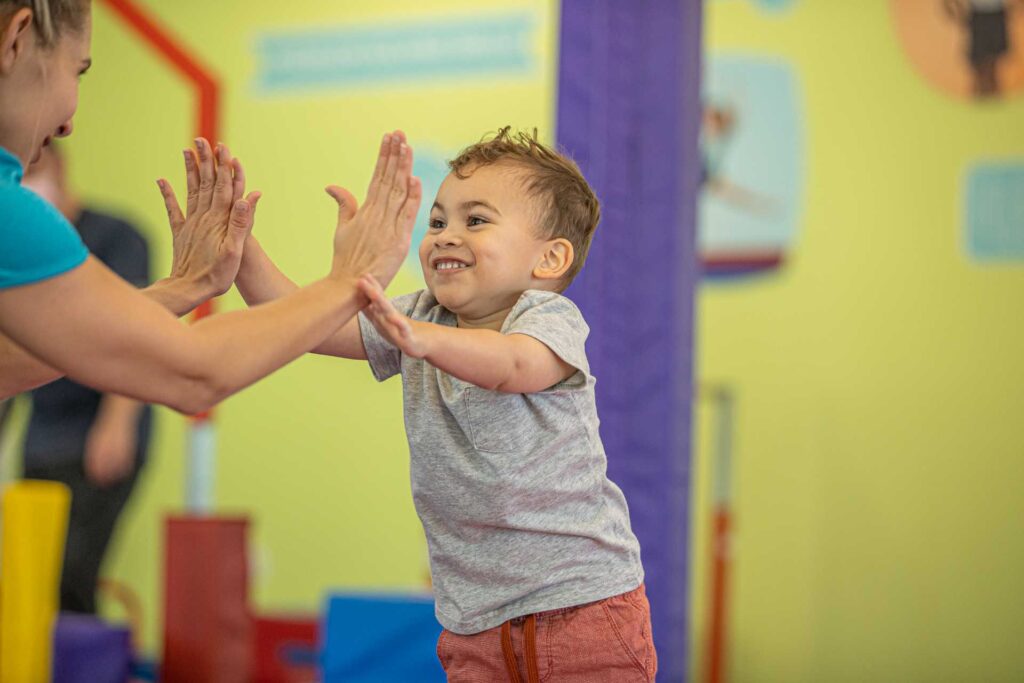 boy giving a woman two high fives