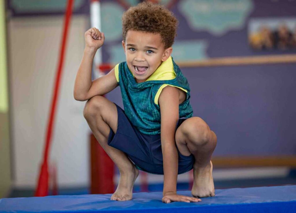 young boy on a gymnastics mat