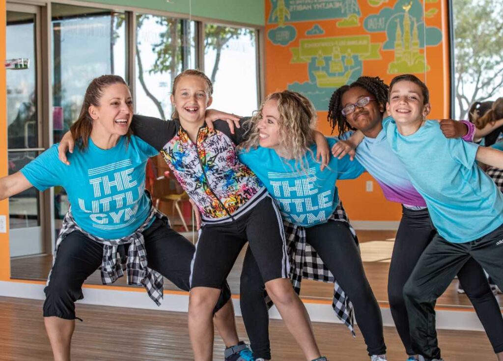 a group of grade school dancers and instructors at the little gym