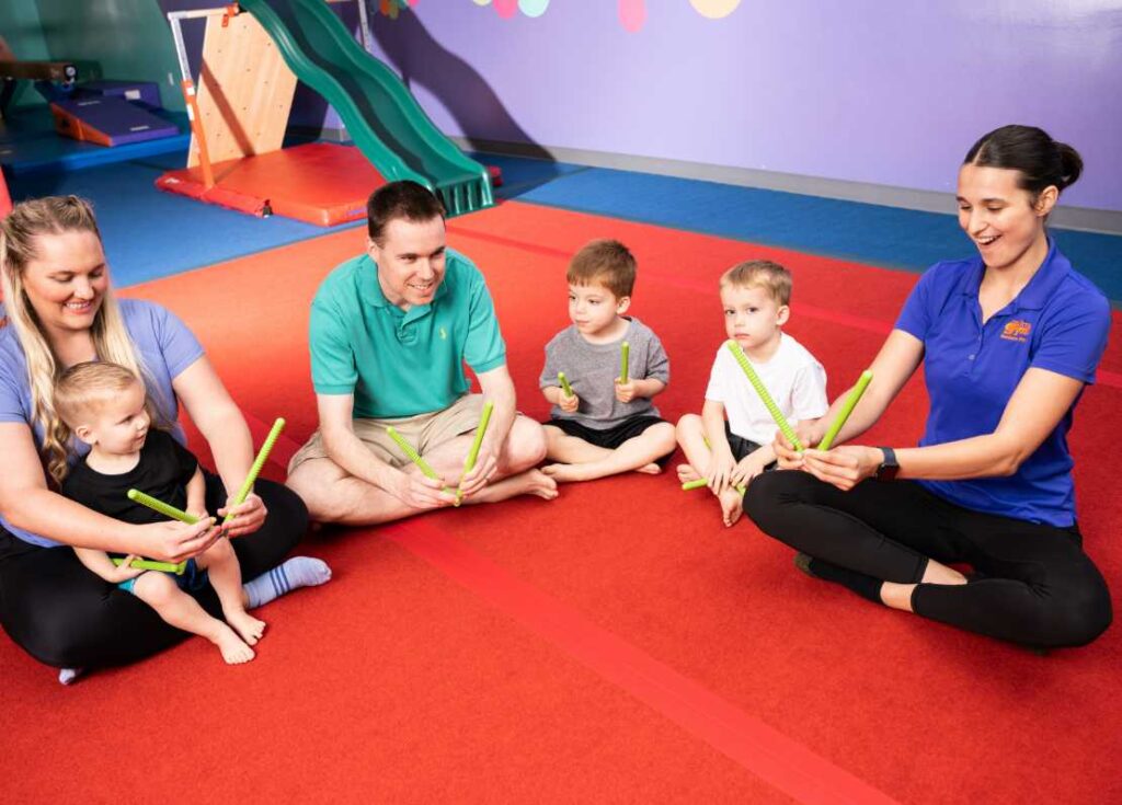 parents and kids in a class at the little gym