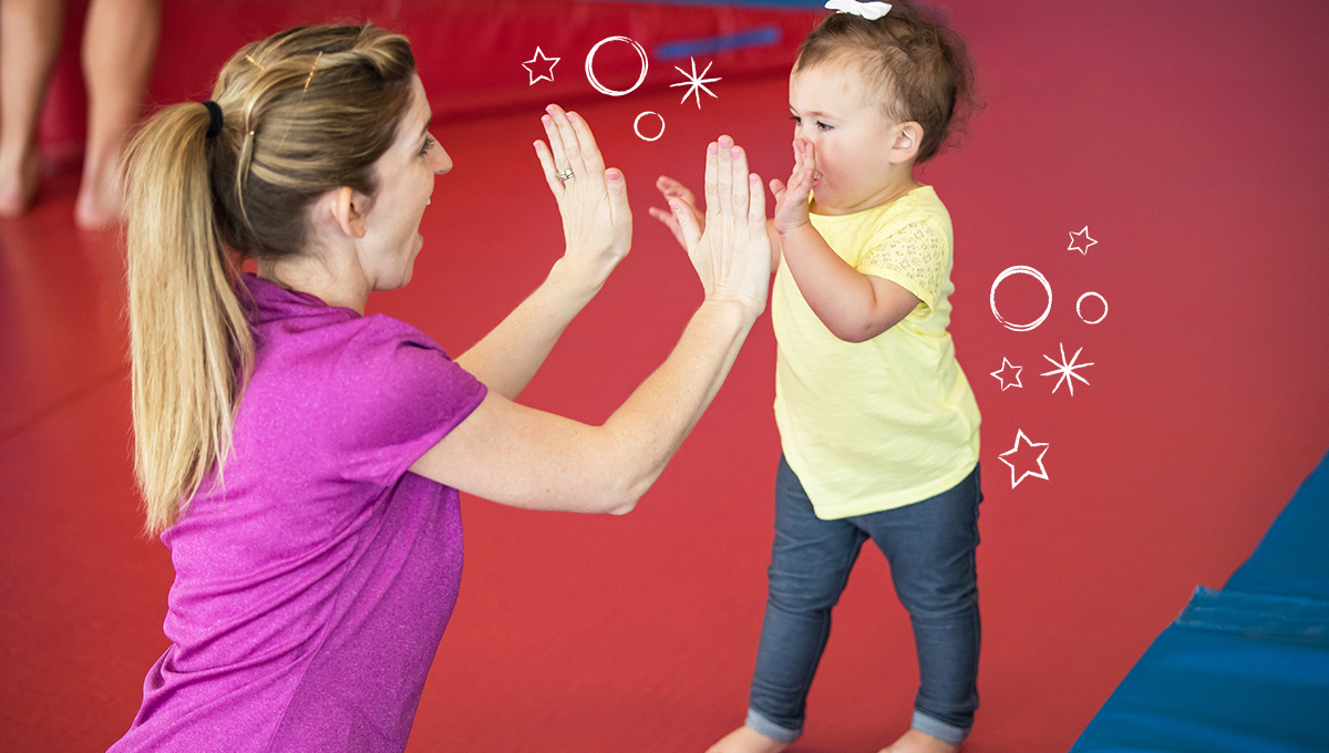 young girl high fiving an instructor