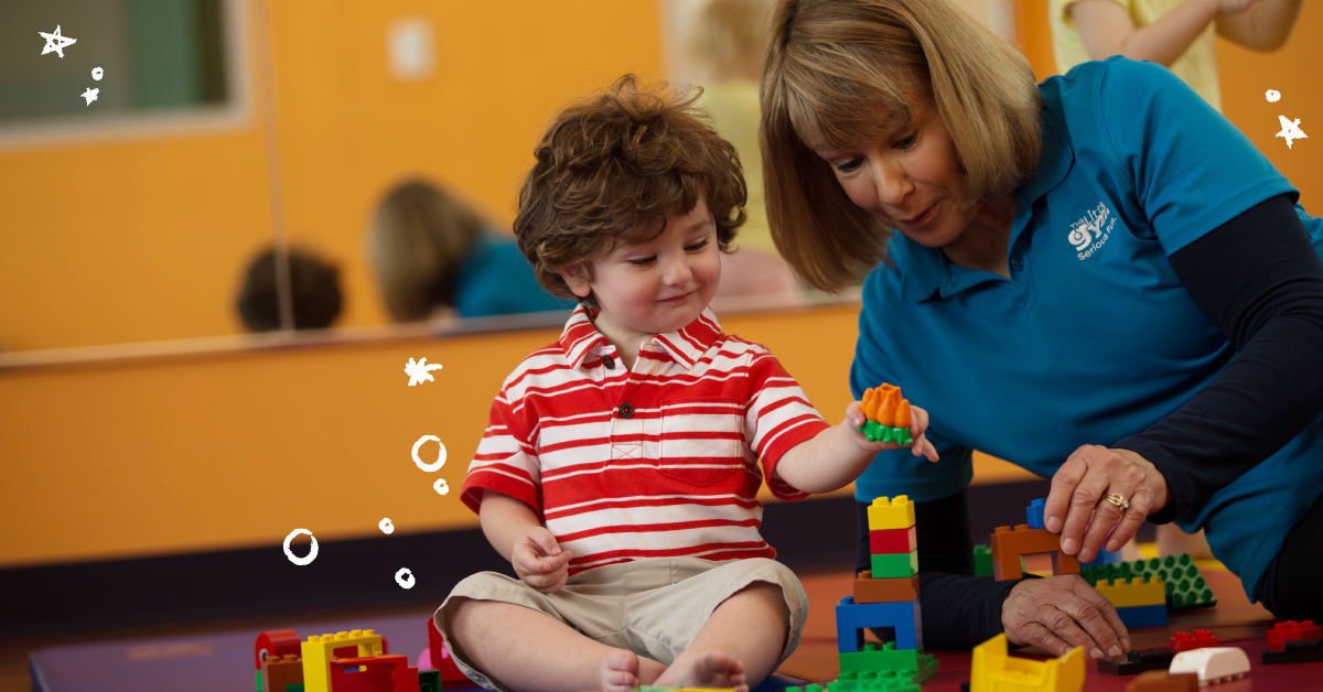 boy building blocks with a little gym instructor