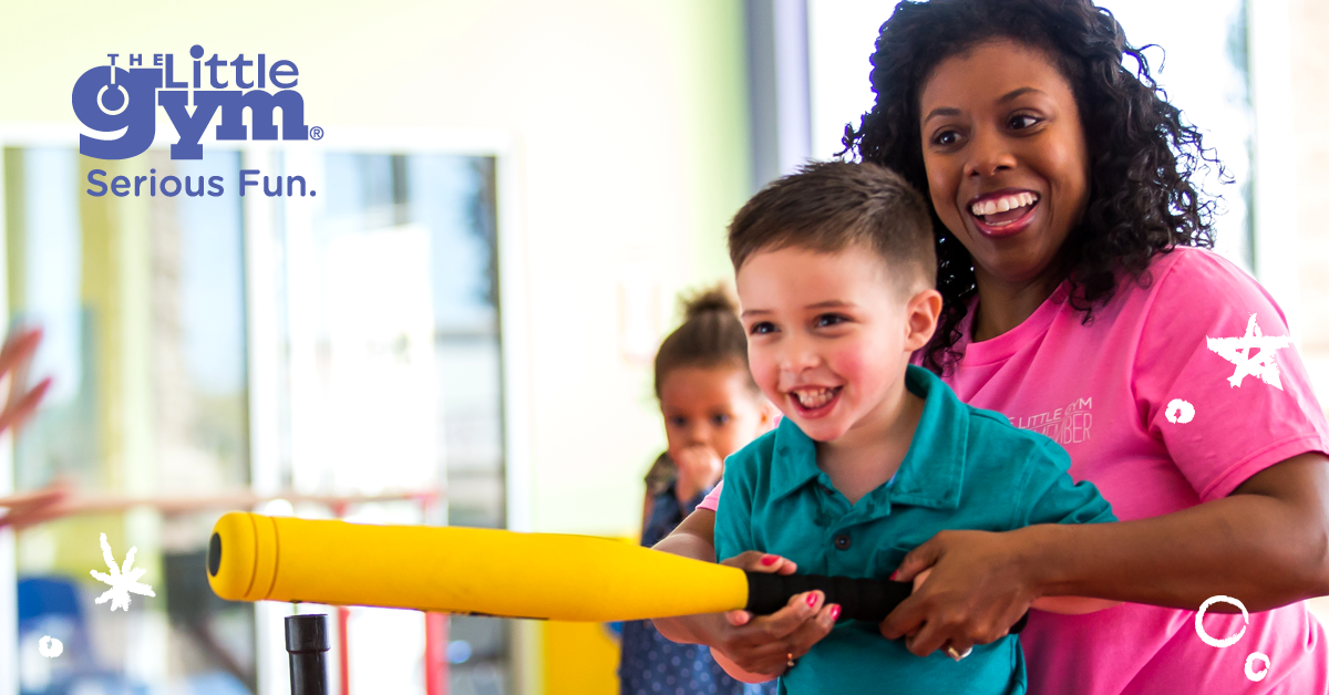 young boy with an instructor at the little gym