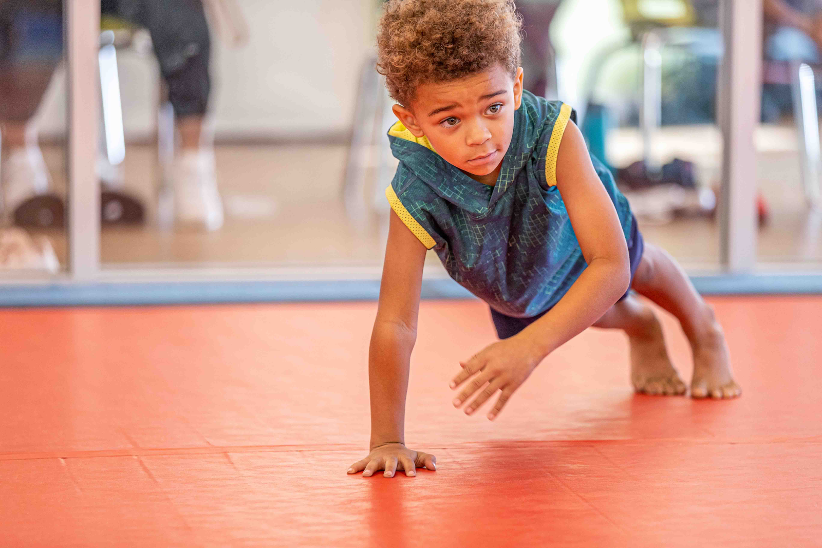 young girl doing an assisted handstand