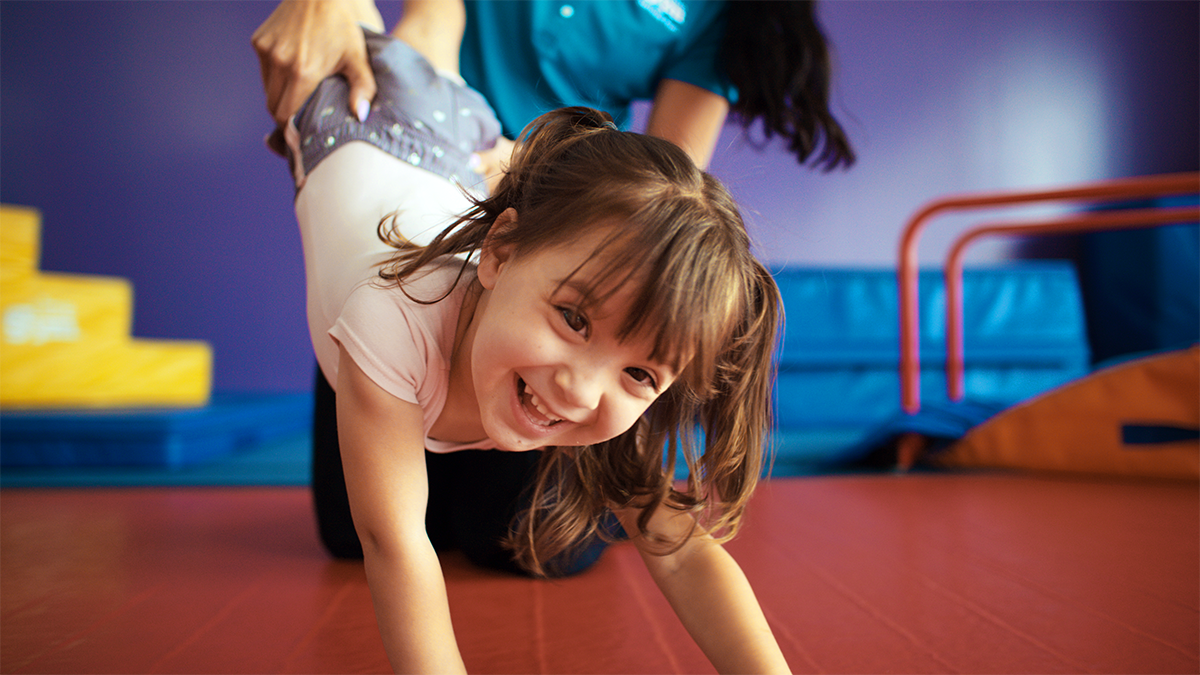 A child playing and building confidence at The Little Gym